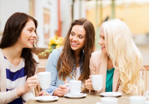 holidays and tourism concept - beautiful girls drinking coffee i